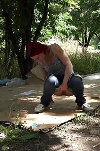 Red-haired Bitch Squatting To Pee Over Cardboard