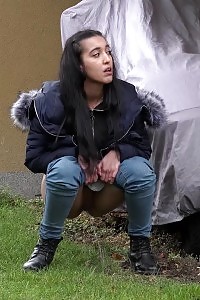 Black Haired European Squats To Piss In Public