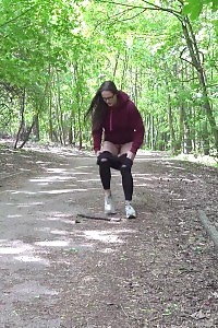 Good-looking Black Haired Girl Squats And Pees Outside