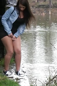 Dazzling Brunette Pisses Into A Flowing Watershed